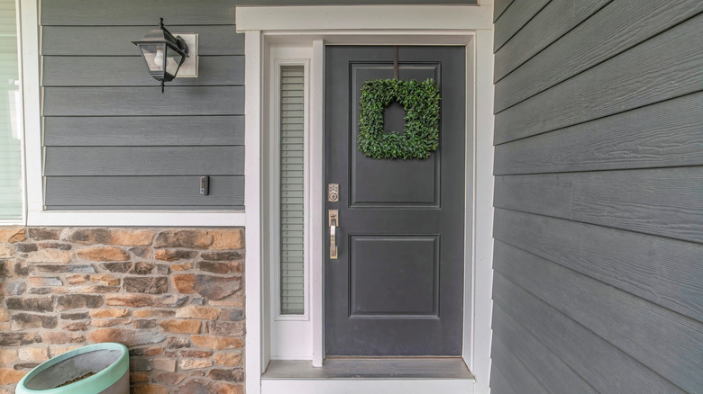 Gray front door with gray house