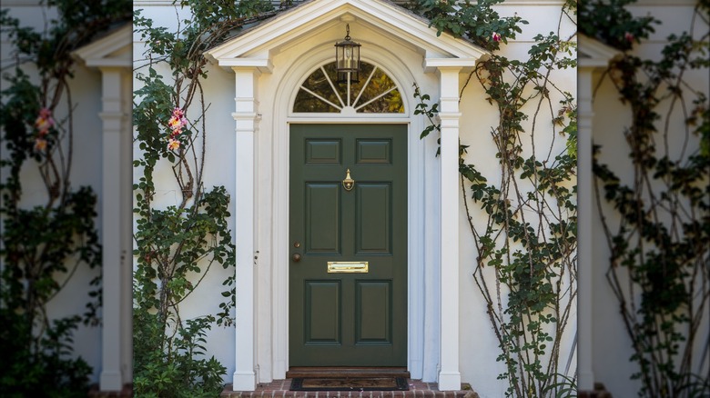 Olive green front door against gray home