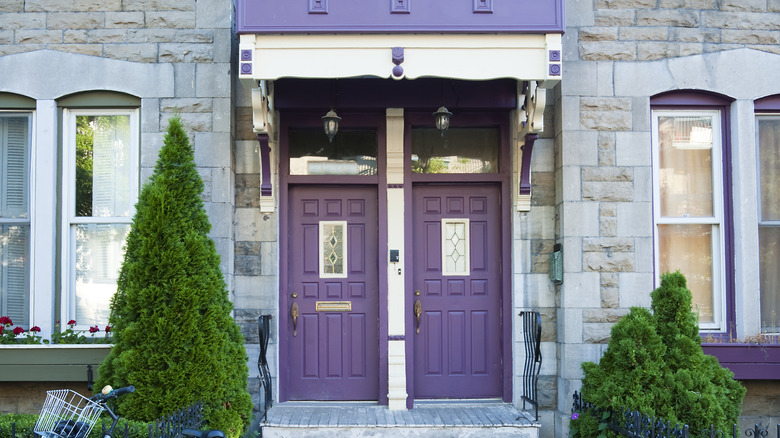 Plum purple door against gray stone house