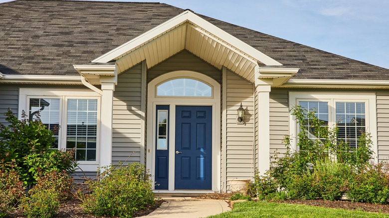 Slate blue front door on gray house