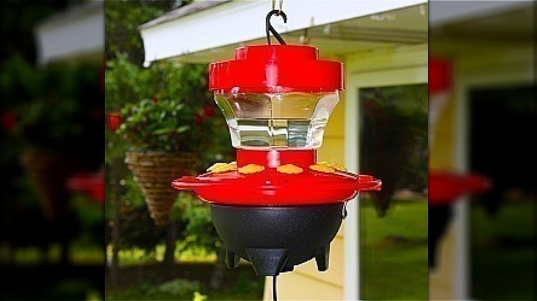 heater underneath red hummingbird feeder