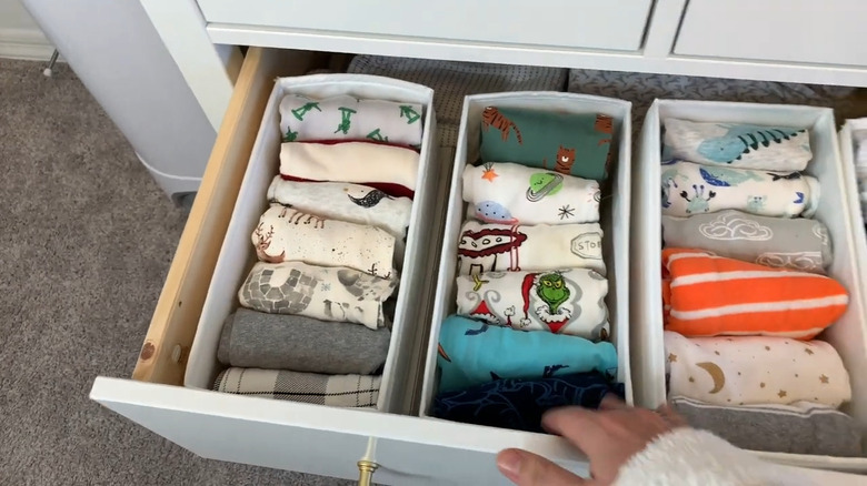 Onesies folded inside IKEA SKUBB boxes in drawer