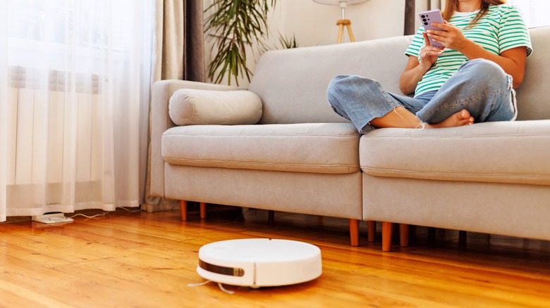 robot vacuum controlled from woman's phone