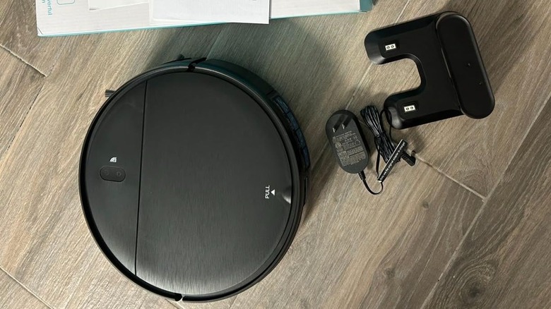 unboxed robot vacuum on wood floor