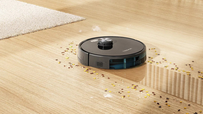 robot vacuum mopping sprinkles on wood floor