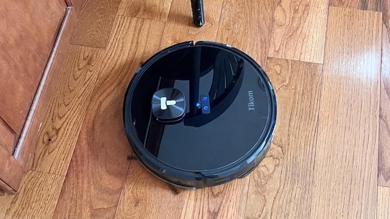 black robot vacuum on traditional hardwood