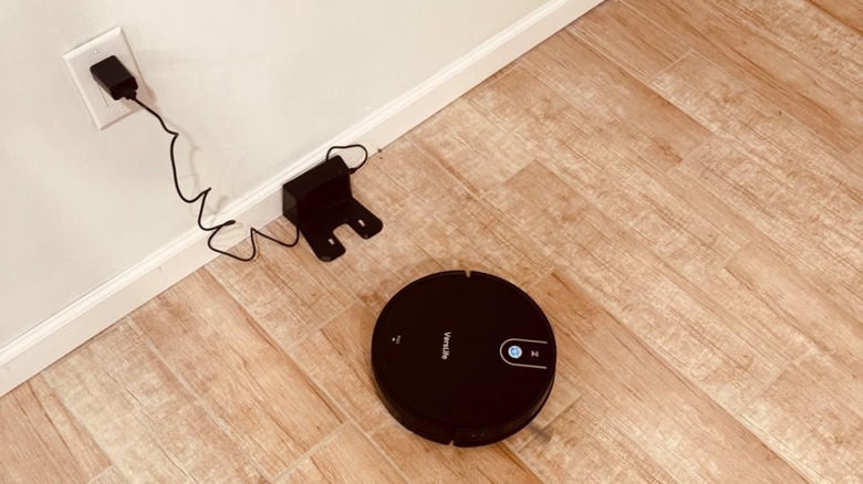 robot vacuum and station on light wood flooring