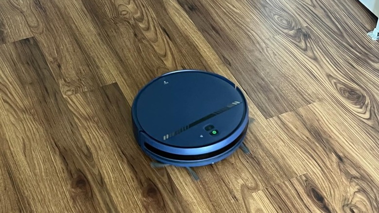 blue robot vacuum on walnut color hardwood