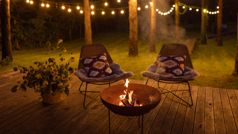 Chairs are arranged around a fire pit