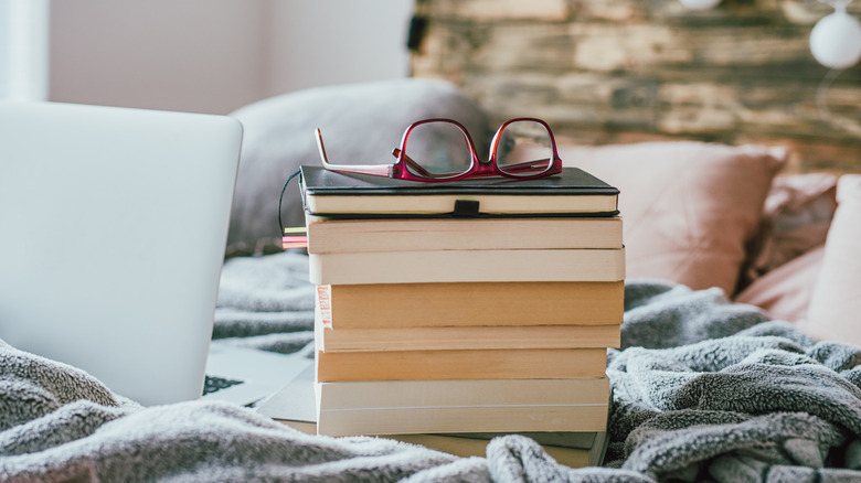 Pile of books on bed