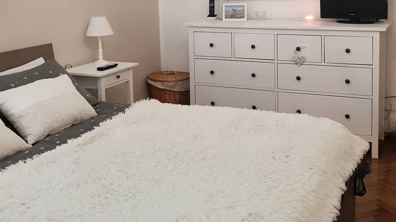 white fur blanket on bed