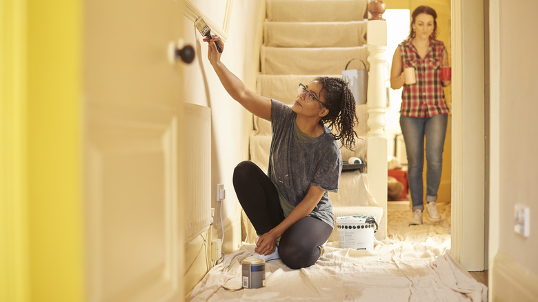 woman painting wall