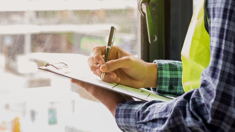 Guy writing on paper