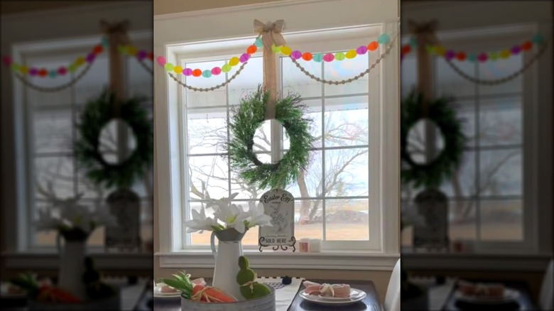 Living room with an Easter egg garland hanging above the windows