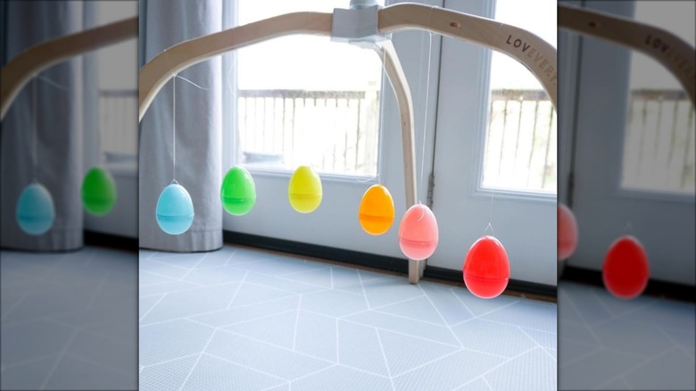 Easter eggs hung from wood into a nursery mobile