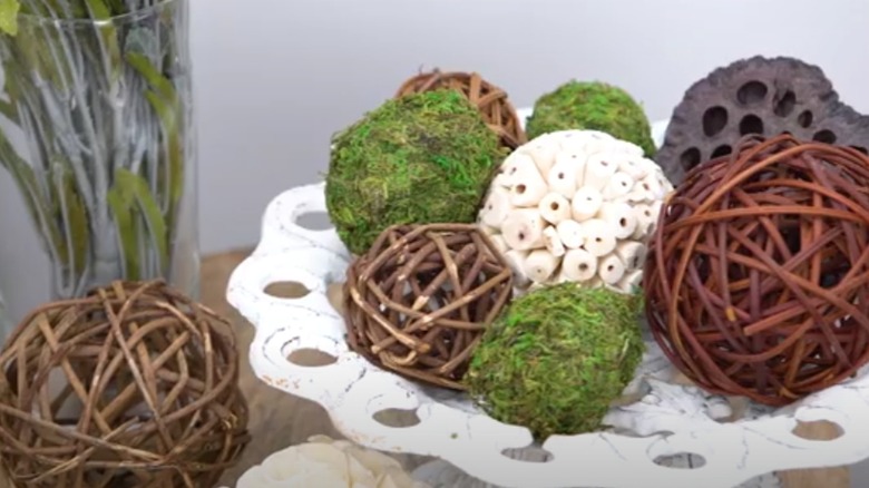 Three plastic eggs decorated with twine and metallic gold foil