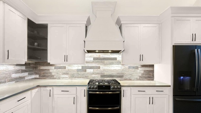 A cabinet with freshly-painted white cabinets