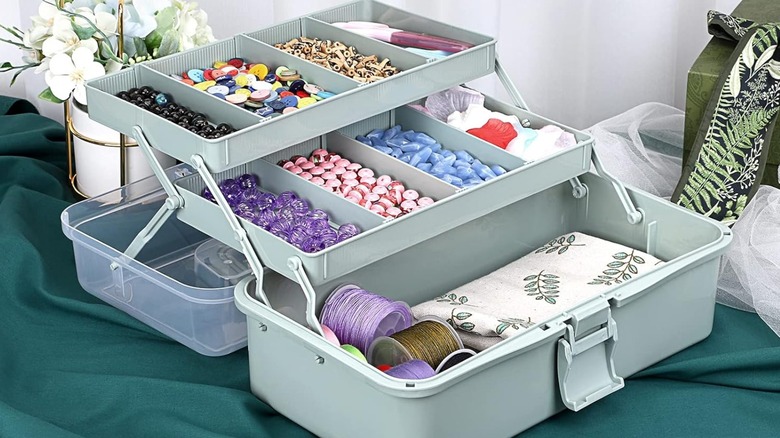 A BTSKY plastic craft organizer filled with beads and twine