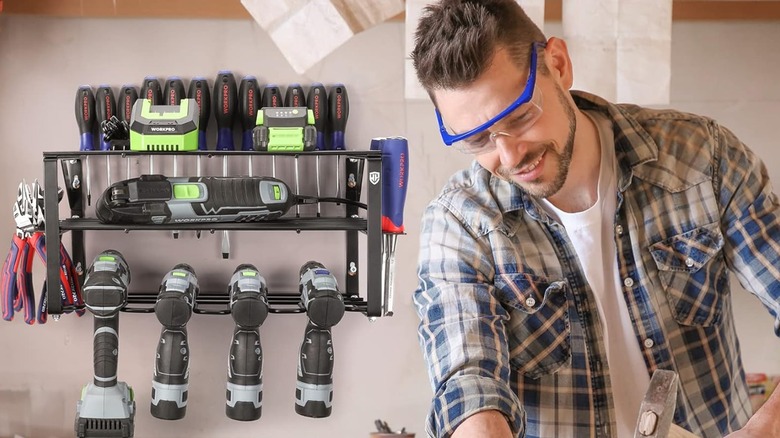 A man wearing safety glasses working in front of a WORKPRO tool organizer