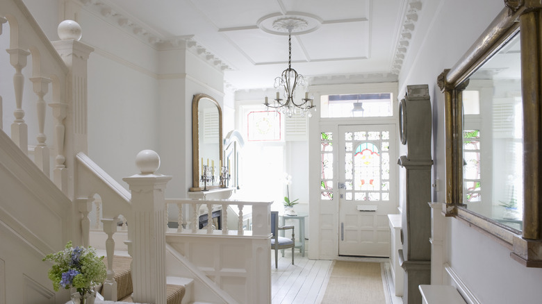 Entryway with a hanging crystal chandelier