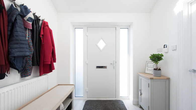 White entryway with jackets on hooks