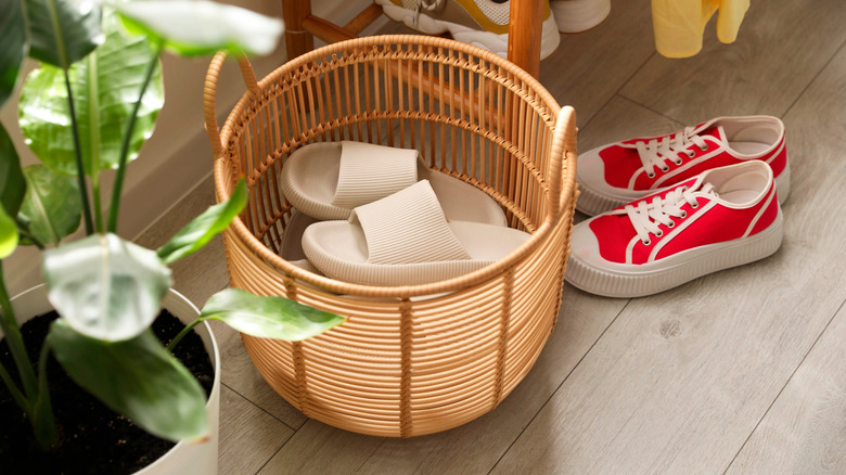 Basket with a pair of white slippers inside