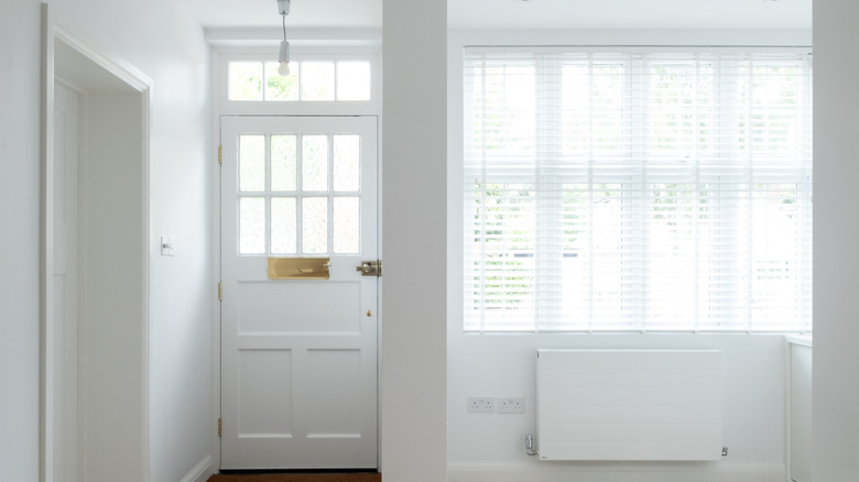 Plain white walls and door in an entryway