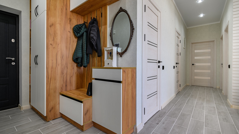 Various closets cabinets and drawers in an entryway