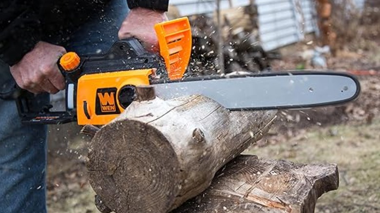 cutting log with chainsaw