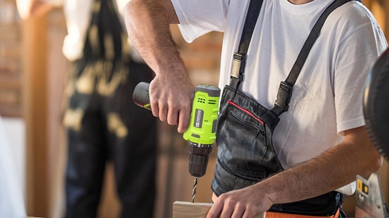 man using cordless drill