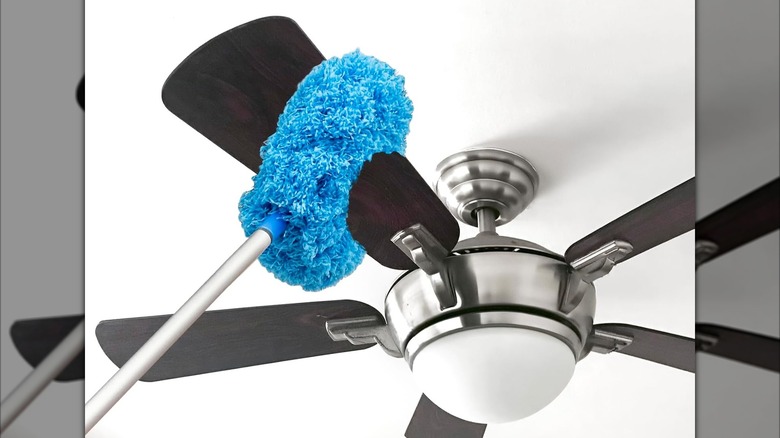 A microfiber dust mop is used on a ceiling fan blade