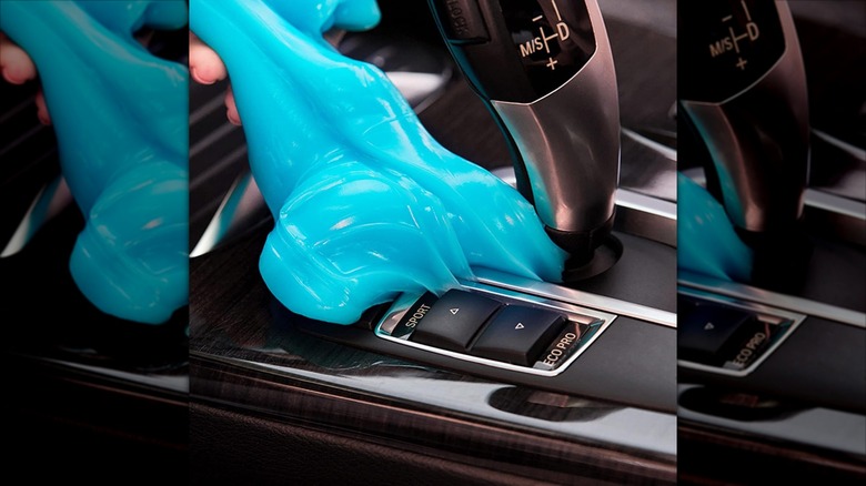 Blue car dust cleaning gel is used on console