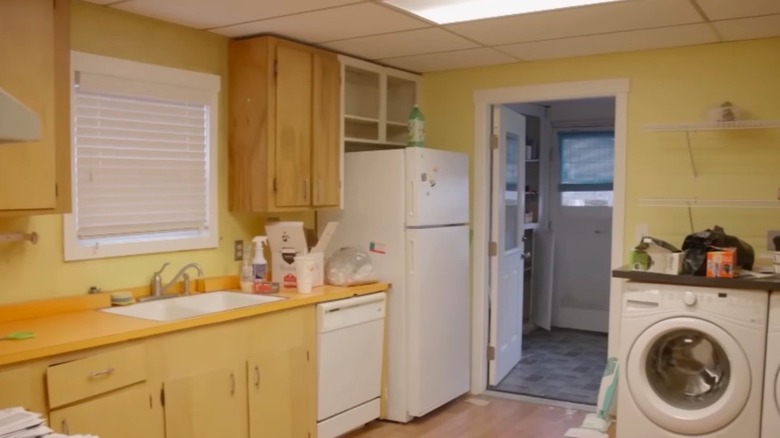Yellow kitchen with laundry machine