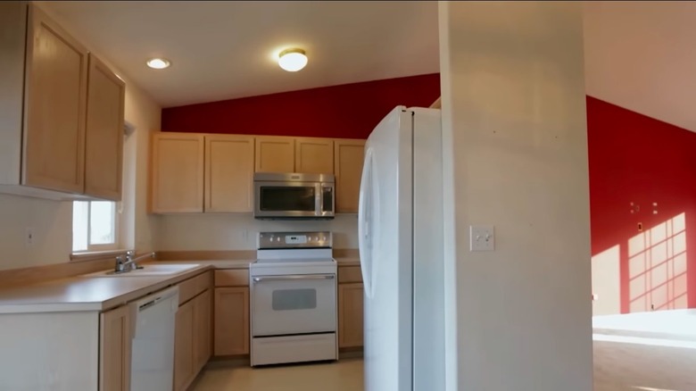 Kitchen next to empty room