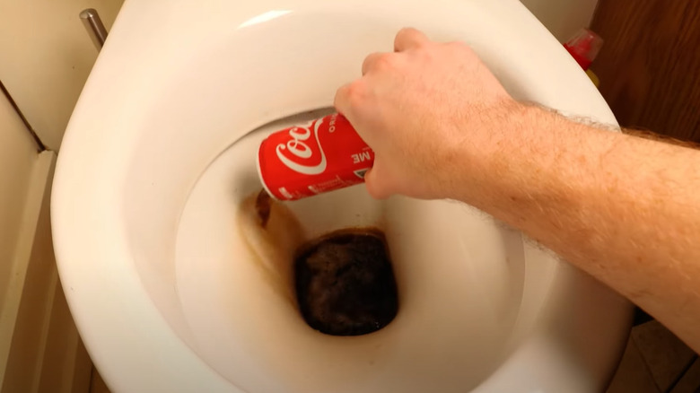 dumping coke in toilet bowl