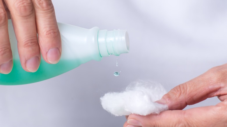 Pouring nail polish remover