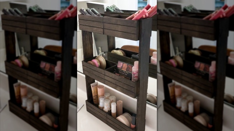 Wooden storage tower full of makeup on bathroom counter