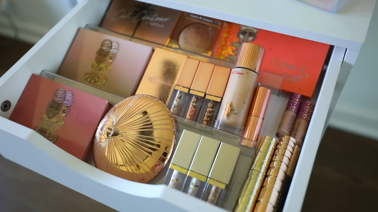 Assortment of makeup and product in a white drawer