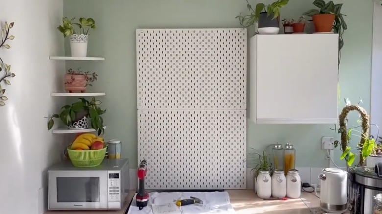 Pegboard being used as a kitchen backsplash