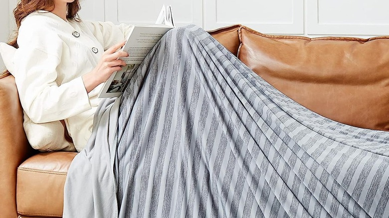 Woman using cooling throw blanket