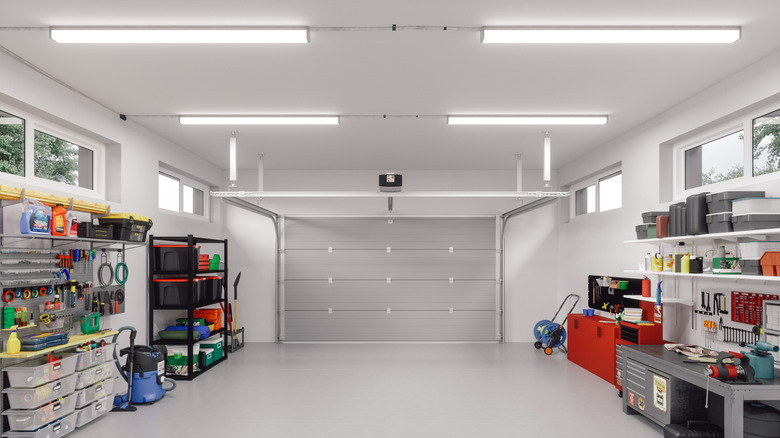 Four bright fluorescent lights illuminate a tidy garage