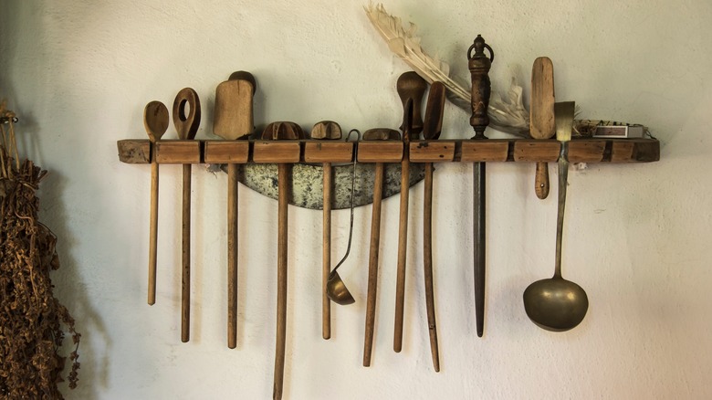 antique kitchen utensils on wall