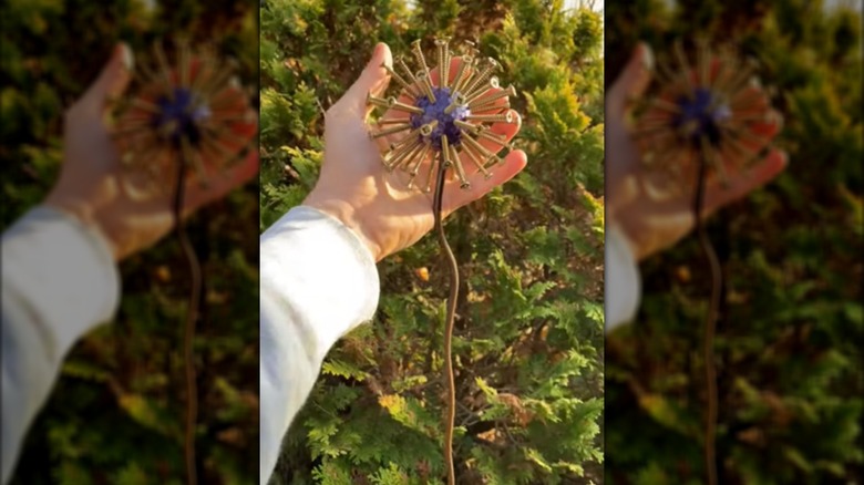 allium garden stake made from golf ball, long wood screws, and a bendable garden stake