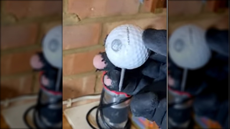 a bradawl made from a golf ball and a long nail