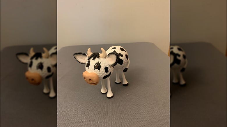 cow made from two golf balls and four golf tees plus accessories