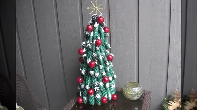 Christmas tree made from green painted spruce cones decorated with red painted golf balls