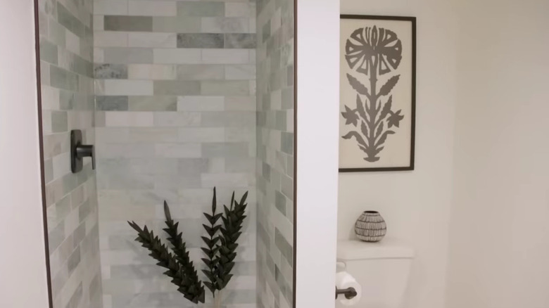 gray tiled shower in white bathroom