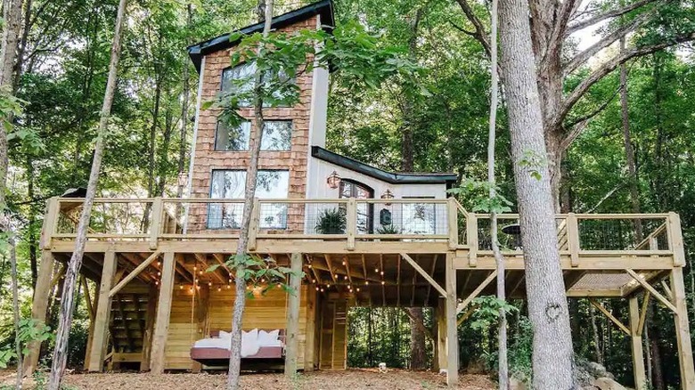 Three-story treehouse lodge in woods