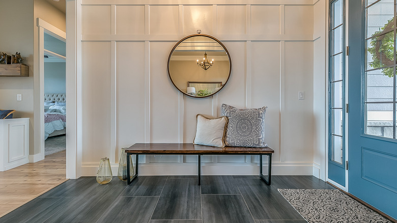 white foyer with a bench