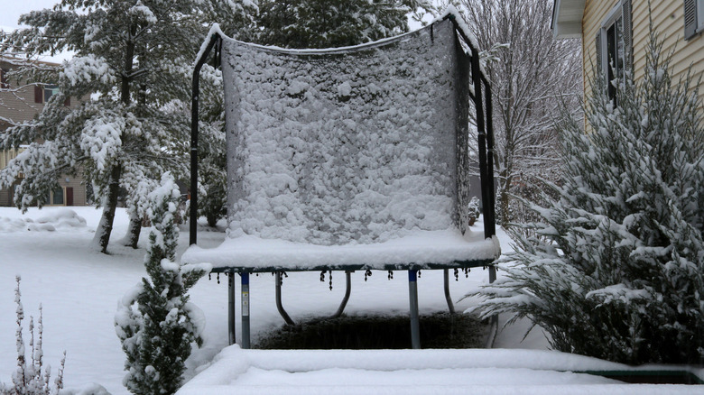 trampoline covered in snow and ice